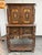Design Plus Gallery presents a 1920's Tudor Revival Carved Walnut Highboard Cabinet by Empire Manufacturing Company. This...