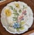 Vintage Italian Nove art pottery earthenware plate featuring a floral motif. The plate is marked on the reverse with "G13V...
