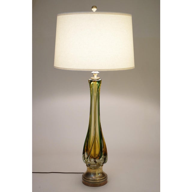 DESIGN: A massive and sculpturally sensual hand blown thick Sommerso Art Glass and Brass table lamp designed and...