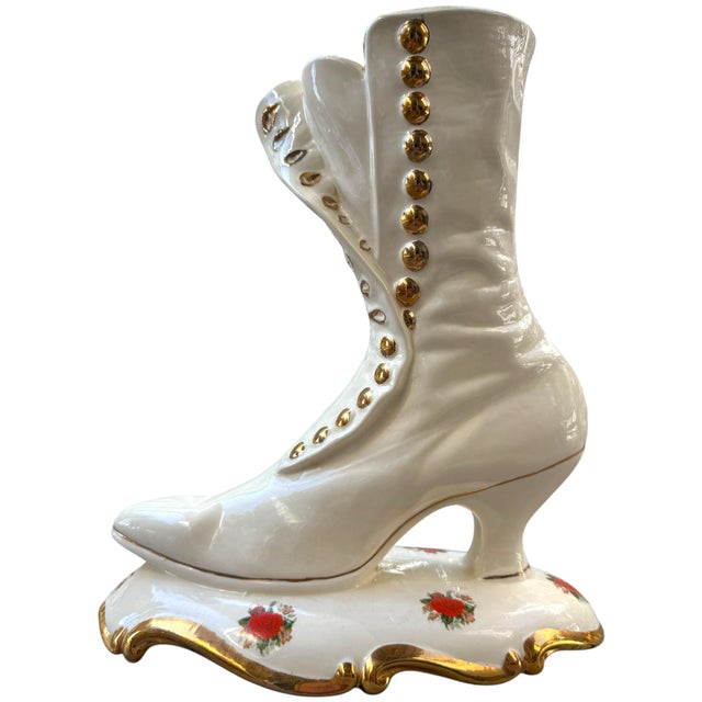 Striking oversized vintage porcelain boot sculptural accent featuring an elegant Victorian-inspired high-heel silhouette,...