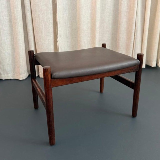 This Scandinavian Modern footstool ottoman was made by the Danish designer Hugo Frandsen for Spøttrup Stolefabrik circa...
