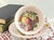 This vintage fine bone china teacup and saucer set was crafted by Royal Grafton in Staffordshire, England. Featuring an...