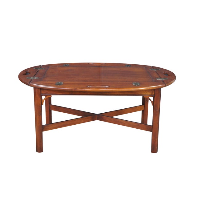 Vintage Attributed to Pennsylvania House English Chippendale / Campaign style butlers tray coffee table. Features an oval...