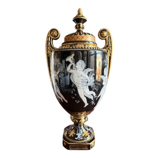 Elaborate Decorative Urn With Original Lid. Cherub Motif With Black and Gold Details. For Sale