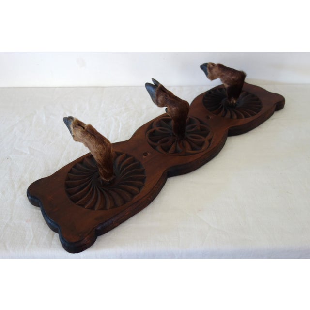 Vintage wall-mounted coat rack made in the Hautes-Alpes region, circa 1960s. Carved Swiss pine adorned with three deer...