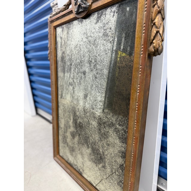 A large neoclassical-style wall mirror, second half of the 20th century, conceived in emulation of late 18th-century...