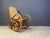 Mid century dark brown wooden and cane webbing rocking chair. These thonet style rocking chair has a very elegant curling...