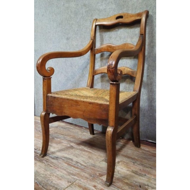 Empire-style armchair in solid walnut with a woven straw seat, in a rustic/provincial style (like a nursery chair or...