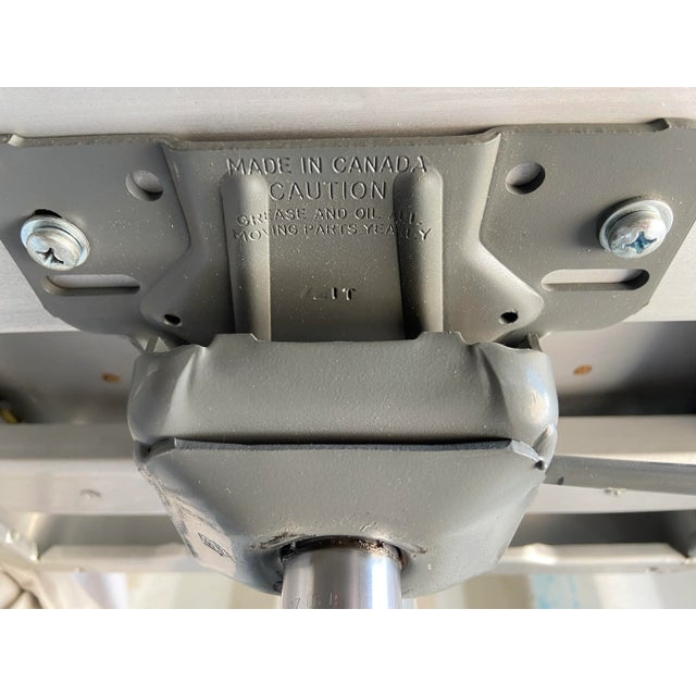 Pre owned emeco navi swivel aluminum desk chair with adjustable height some scuffs and marks and minor rip on the leather...