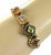 This vintage bracelet features four charms on a double chain, with each charm representing different multicolor gems set...
