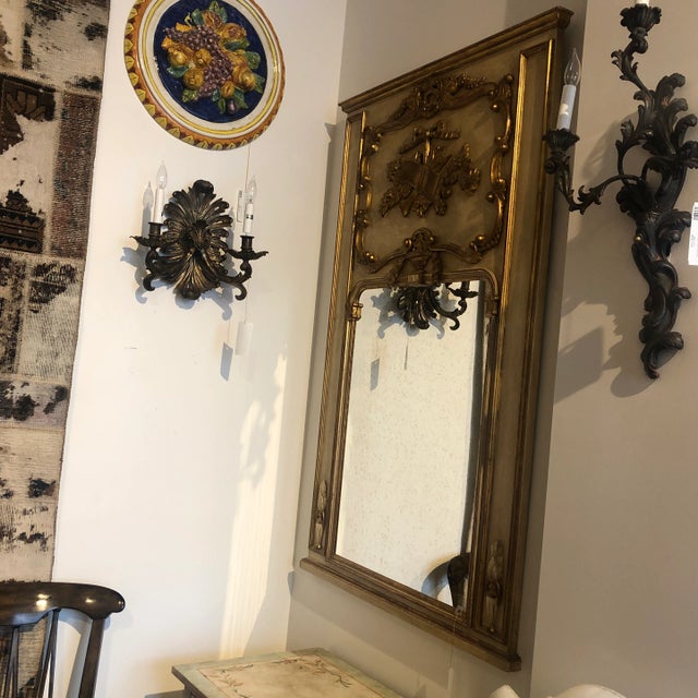 Hand painted Italian mirror in a distressed finish with gold leaf over red painted detailing. Circa 1970's.