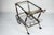 Elegant mid-century Italian bar cart featuring a refined brass frame with pierced gallery details and two clear glass...
