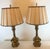 This sophisticated pair of lamps gleam in metallic tones of brass. They feature detailed sections and elegant tiers that...