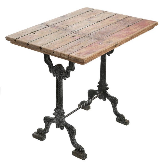 Cast iron and patinated wood bistro table. This piece is designed in the style of the selected designer and/or manufacturer