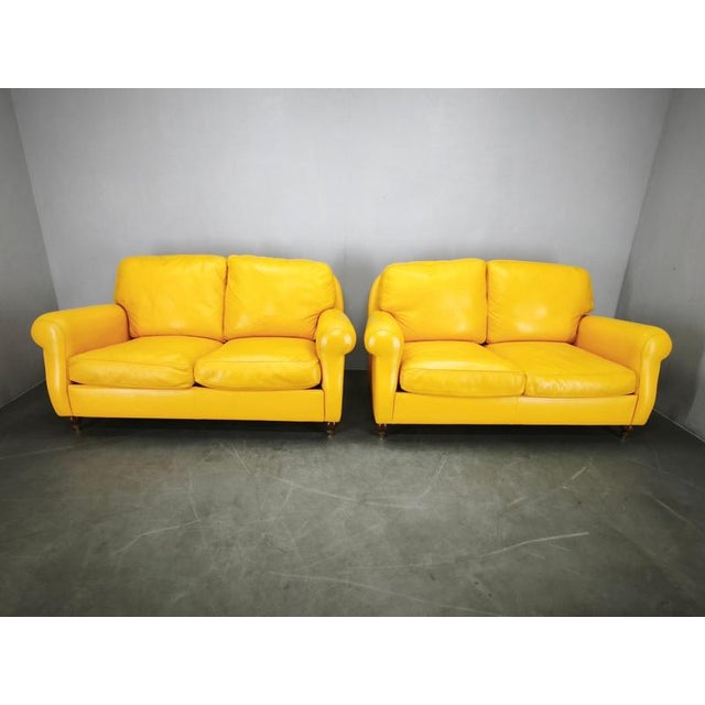An outstanding pair of Poltrona Frau “George” leather sofas, manufactured in Italy in 1992 and preserving their original...