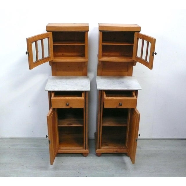 Two antique Biedermeier bedside tables with attached glass-fronted display cabinets, the cabinets are made of softwood,...