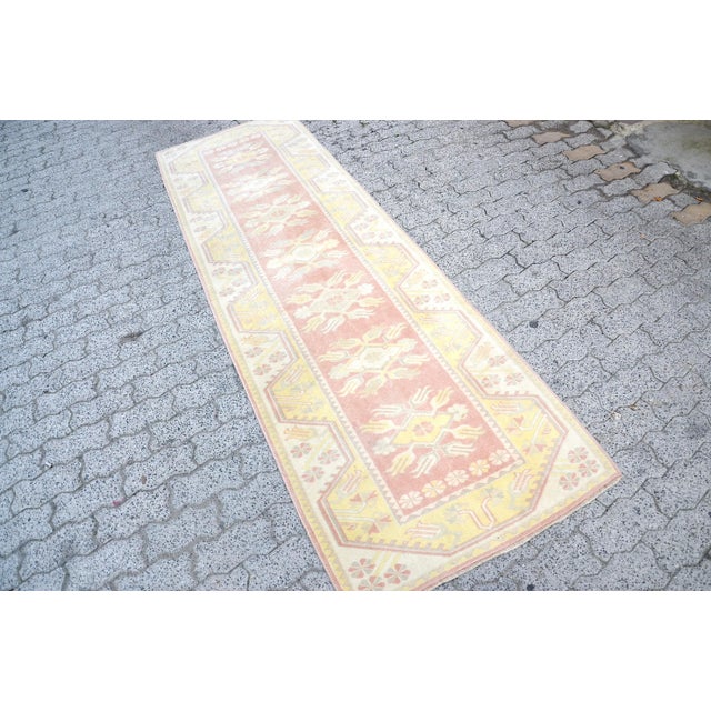 This is a vintage Turkish Oushak rug from the 1960s. The piece was hand-knotted.