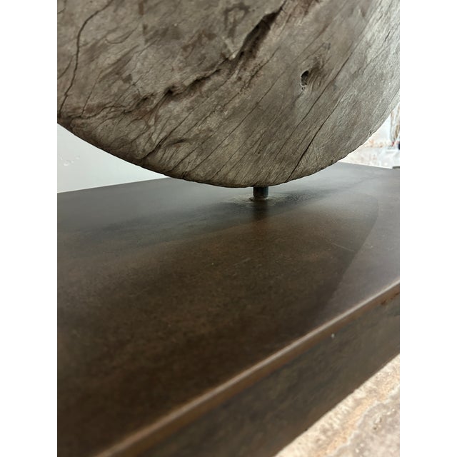 Exceptional primitive statement artifact featuring a heavily weathered antique hardwood wheel. The heavy block base is...