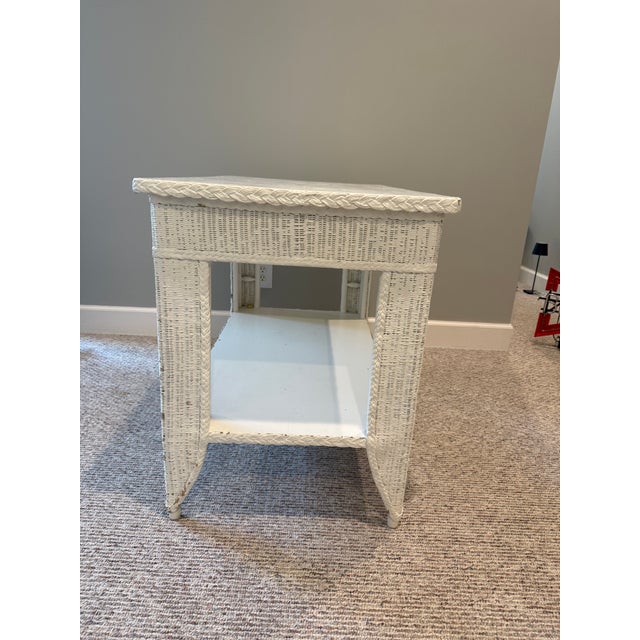 This antique wicker library table offers timeless appeal. Its intricate woven design and white finish create a...