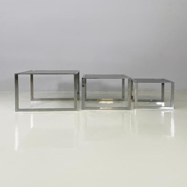 Italian modern Trio of coffee tables in smoked glass and metal, 1980s Trio of fantastic coffee tables with square smoked...