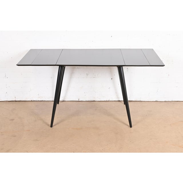 A sleek and stylish Mid-Century Modern extension dinette table or game table By Paul McCobb for Winchendon Furniture,...