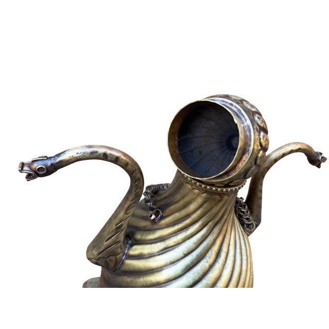 Spiraling deep into the solid brass core, the fluted channels of this heavy vessel create a relentless play of light and...