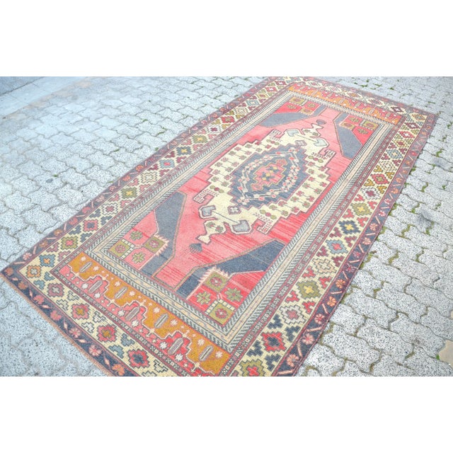 This is a vintage Turkish Oushak rug from the 1960s. The piece was hand-knotted.