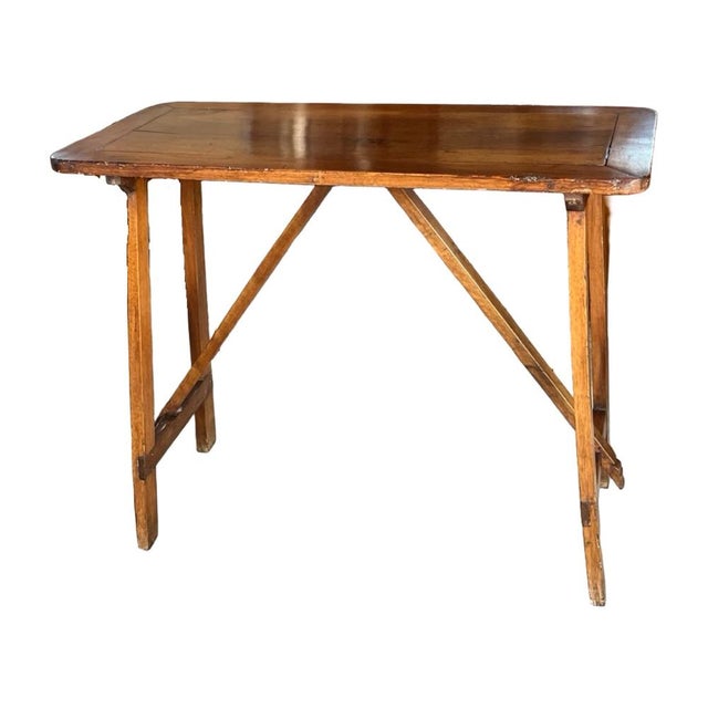 Small capretta table hand-made in Italy in the early 1900s using walnut and pegged construction. The table is tall and...