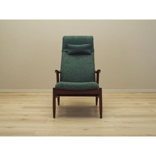 The armchair was made in the 1970s, Danish production. The legs are made of solid teak. The armchair has undergone...