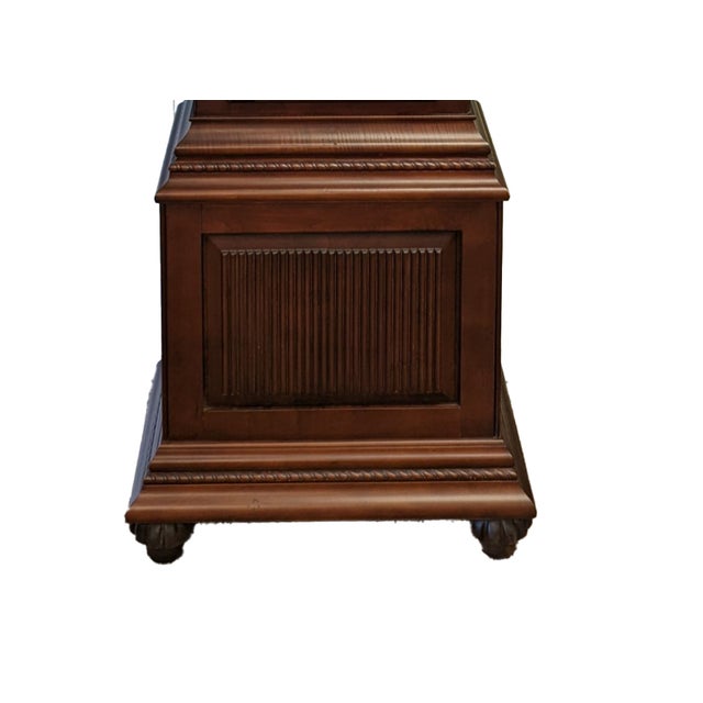 Lightly-distressed cherry-finished hardwood cabinet; curved bonnet top with carved fan sunburst; bubbled glass in top...