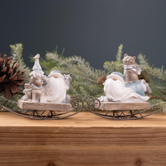 Add a touch of winter magic to your home with these charming Gnome on Sled Figurines. Hand-painted with wintry blue and...