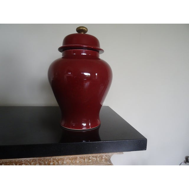 A beautiful Oxblood Temple Jar with a Brass Finial
