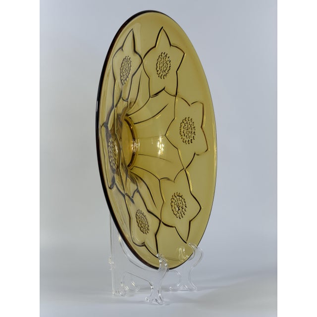 A striking large-format vintage glass centerpiece dating to circa the 1960s, executed in warm amber-colored glass and...