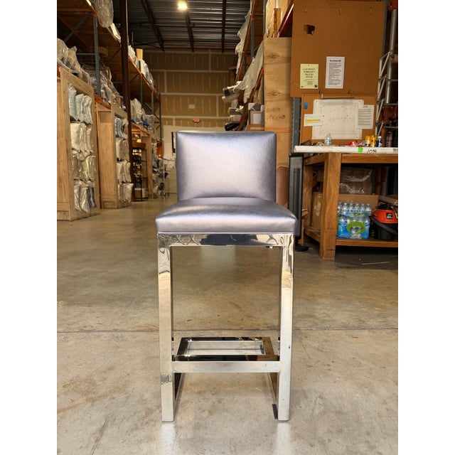 Contemporary counter stool featuring a striking metallic indigo leather seat and back with a smooth, tailored silhouette...