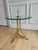 A sophisticated 20th-century drinks table featuring a minimalist tripod base in solid brass. This piece seamlessly blends...