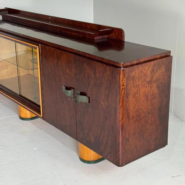 A truly remarkable 1930’'s credenza from Belgium, showcasing a very elegant mix of mahogany wood on the sideboard itself...