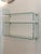 A set of three Mod. Babila wall shelves in curved glass with chrome-plated metal brackets, manufactured by Fiam Italia....