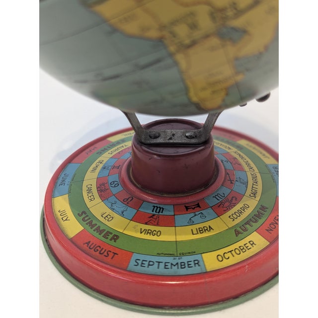 American lithographed tin desktop globe featuring historical political cartography mounted on a vividly printed perpetual...
