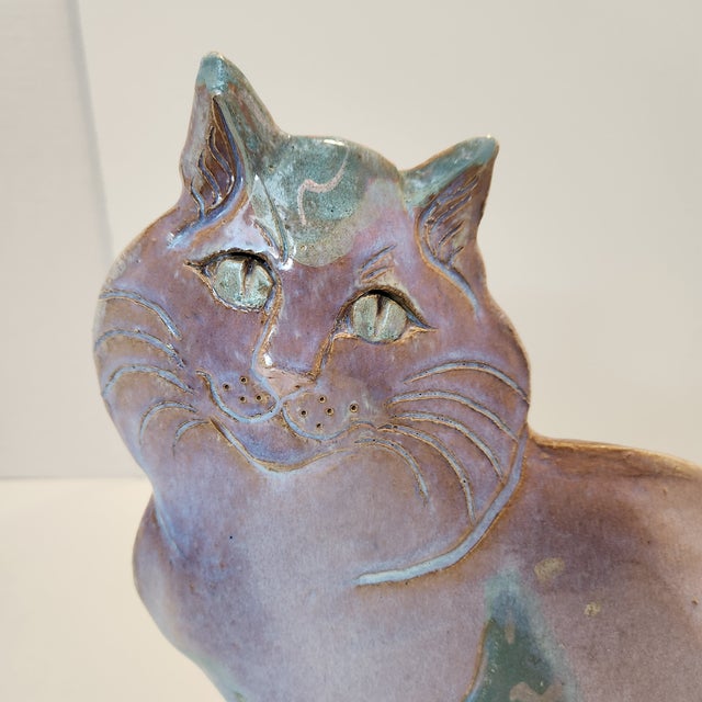Bring a touch of whimsical, artisanal charm to your space with this exceptional vintage studio art pottery cat figurine....