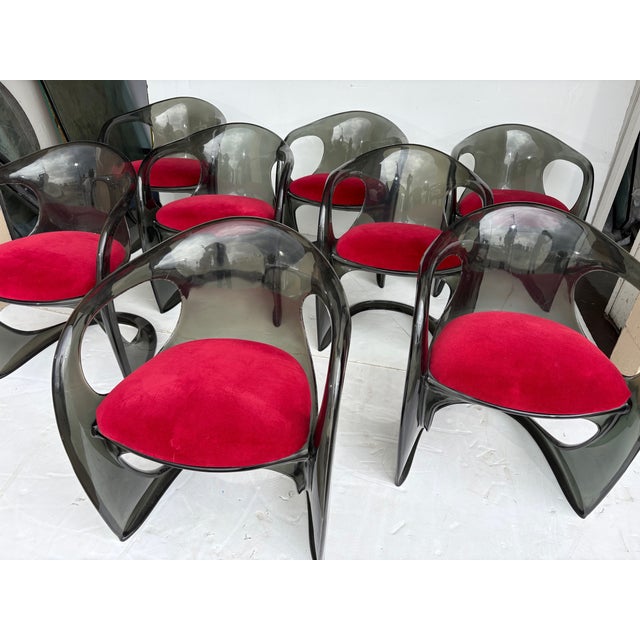 A set of smoky Lucite dining chairs. The seats can be removed and recovered.