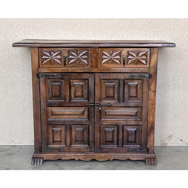 from Northern Spain, constructed of solid walnut, the rectangular top with molded edge atop a conforming case housing two...