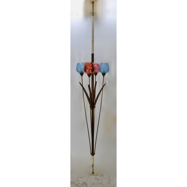 We are featuring a Italian Mid-Century Modern tension floor lamp with four lights. The stained glass shades are cranberry...