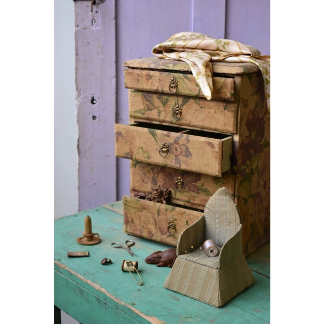 Antique Floral-Printed Fabric Covered Tabletop Haberdashery Cabinet, Circa Early 20th Century. Wood base construction with...