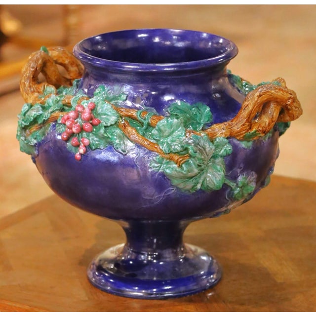 Crafted in France and signed and dated 1858, this striking antique barbotine pedestal urn features a richly glazed cobalt...