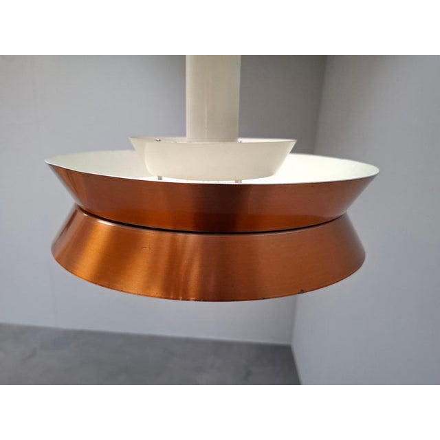 This vintage danish pendant lamp was designed by carl thore and produced by granhaga during the 1960s. The lamp features a...
