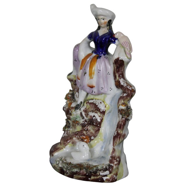 Antique 19th century staffordshire porcelain figure showing a young woman seated on the rocks above a waterfall with two...