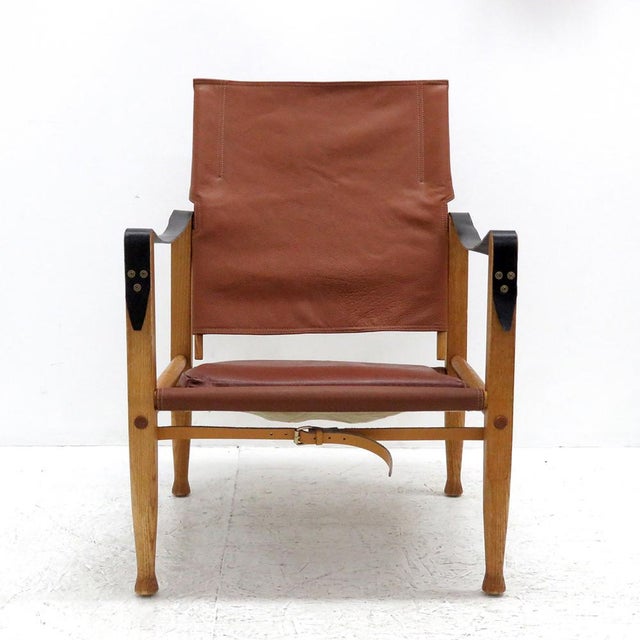 wonderful safari chair designed by Kaare Klint for Rud. Rasmussen’s Snedkerier, with patinated ash frame, seat, back,...
