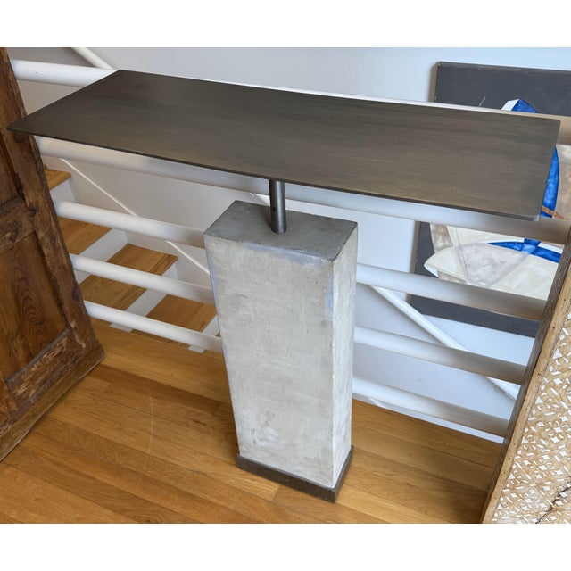 Sleek, sculptural, and effortlessly refined, this custom minimalist console table by Hastening Designs brings modern...