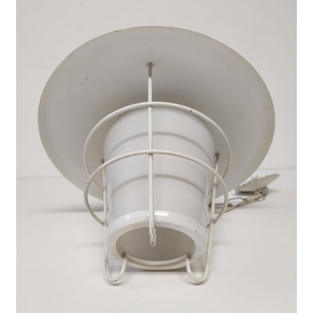 This ceiling light is attributed to Stilnovo for form and style. No logo and mark. This piece is attributed to the...
