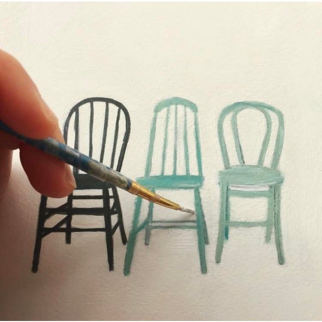 A small, unframed oil on archival paper study of a grouping of blue chairs. painted by Lara Felsing.